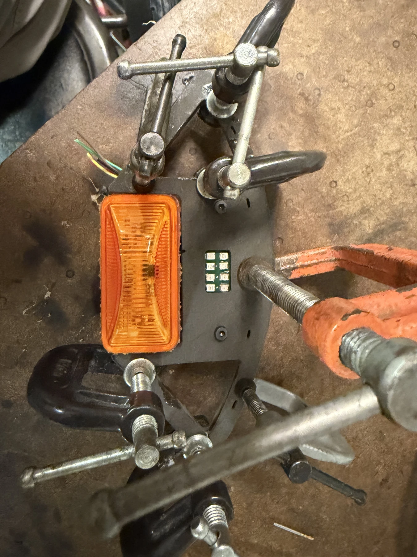 Temporary clamps hold the assembly in position while the epoxy cures.