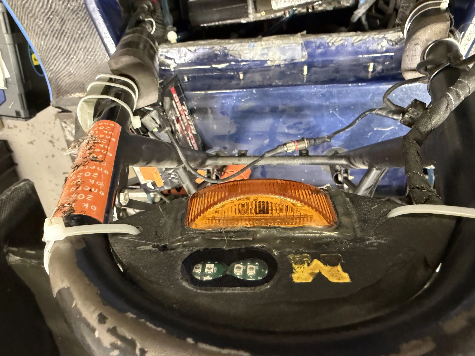 The assembly installed near the vehicle roll hoop.